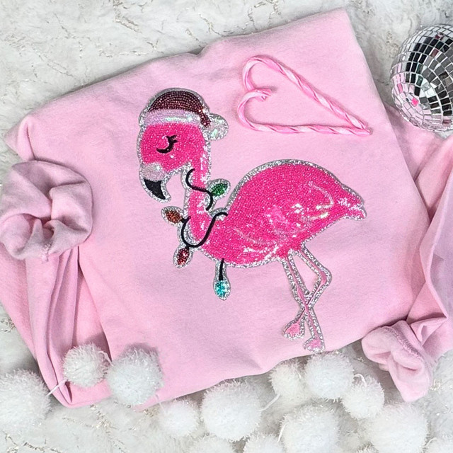 Christmas Flamingo Sequin Patch, pink flamingo with Sequin embellishments on a pink fabric background.