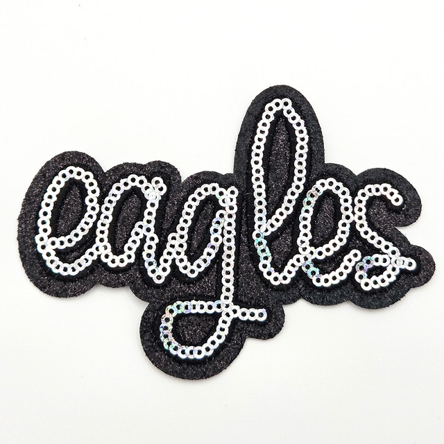 Eagles Silver Sequin HAT/POCKET Patch, decorative patch with the word 'eagles' in black glittery fabric outlined with silver sequins.