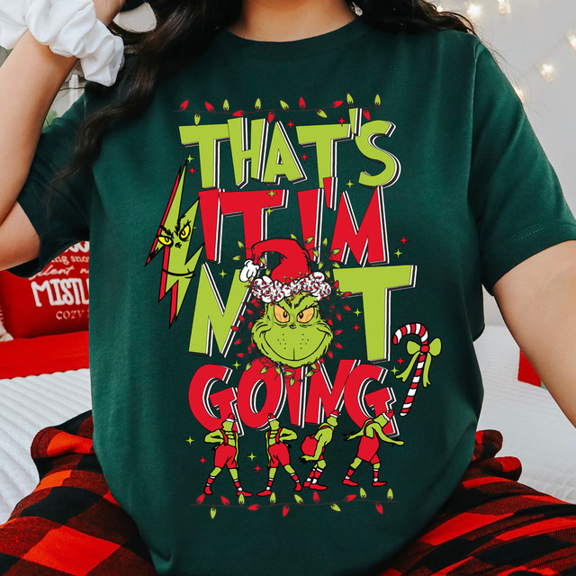 That's It Green Guy DTF Heat Transfer, holiday-themed graphic design featuring the grinch in a Santa hat and Christmas lights on a green t-shirt.