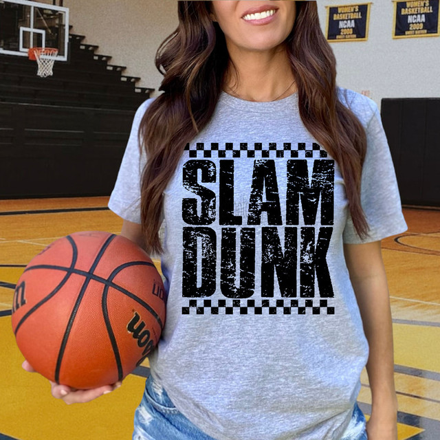 Distressed Slam Dunk BLACK DTF Heat Transfer, female basketball player holding a basketball in a gymnasium with banners in the background.