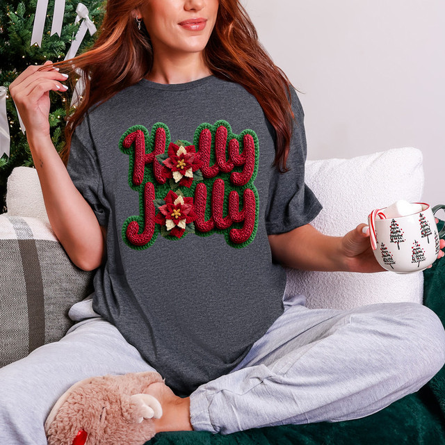 Faux Yarn Holly Jolly Poinsettia DTF Heat Transfer on a woman's grey t-shirt, with festive Christmas lettering and poinsettia flowers design.