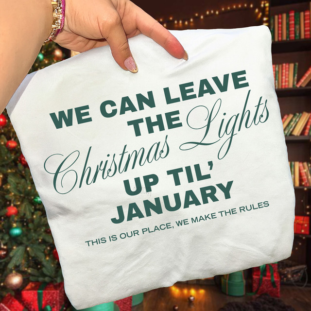 We Can Leave the Christmas Lights Up 'Til January GREEN DTF Heat Transfer, a decorative fabric with festive holiday quote displayed in a cozy Christmas setting.