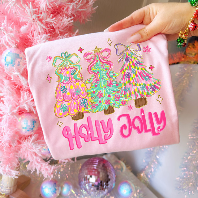 Holly Jolly Trees DTF Heat Transfer, colorful embroidery of three decorated Christmas trees on pink fabric, with festive background of pink Christmas tree and ornaments.