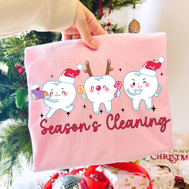 Season's Cleaning Dental Christmas DTF Heat Transfer, holiday-themed dental cartoon characters on pink fabric with Christmas decorations in background.