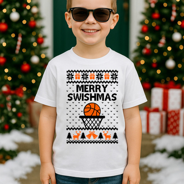 Merry Swishmas DTF Heat Transfer, a festive Christmas-themed t-shirt featuring a basketball hoop with a basketball, holiday ornaments, and decorations on a child's white shirt.