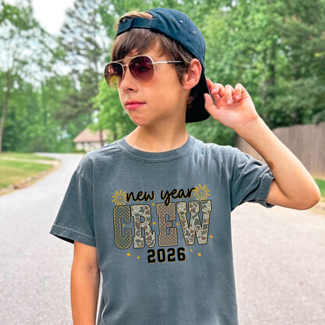New Year Crew 2026 Pattern DTF Heat Transfer, a festive and stylish design on a gray t-shirt worn by a young boy outdoors.
