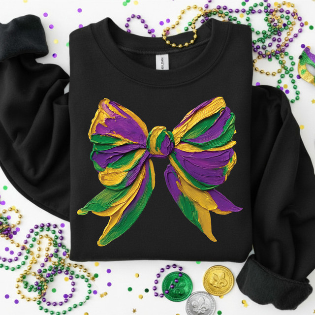 Faux Painted Mardi Gras Bow DTF Heat Transfer, black sweatshirt featuring a colorful, textured bow design in purple, green, and yellow with Mardi Gras theme.