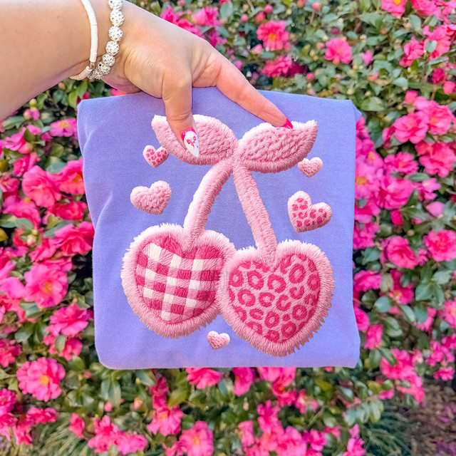 Faux Yarn Pink Pattern Heart Cherries DTF Heat Transfer, embroidered pink cherries with heart patterns on a light purple fabric background.