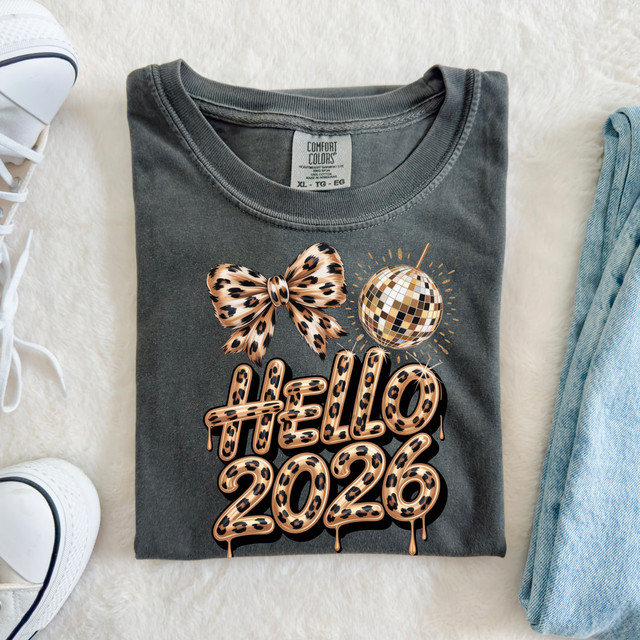 Leopard Hello 2026 DTF Heat Transfer, graphic t-shirt with leopard print text, leopard bow, and disco ball design.
