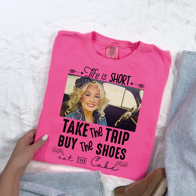 Life Is Short Take The Trip Buy The Shoes Eat The Cake DTF Heat Transfer, pink t-shirt with a quote and a photo of a smiling woman in a car.