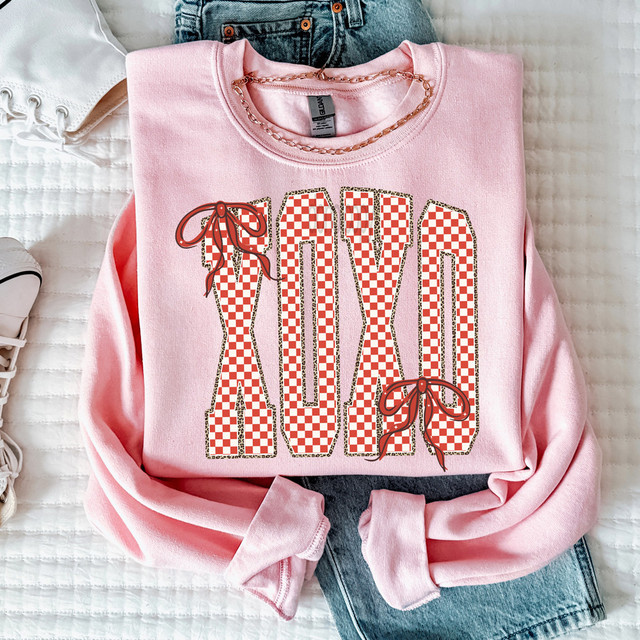 Checkered XOXO Bows DTF Heat Transfer, pink sweatshirt with red and white checkered 'LOVE' design and bow accents.