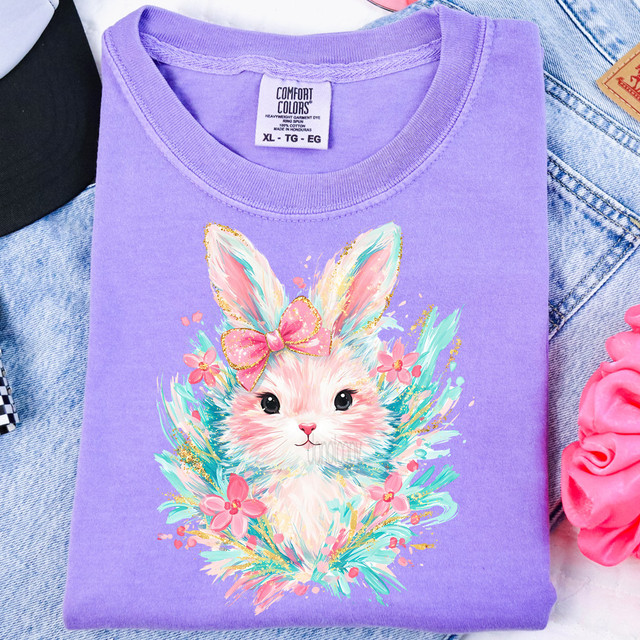 Coquette Easter Bunny Wreath DTF Heat Transfer, purple t-shirt featuring a colorful illustration of a bunny with a pink bow and flowers