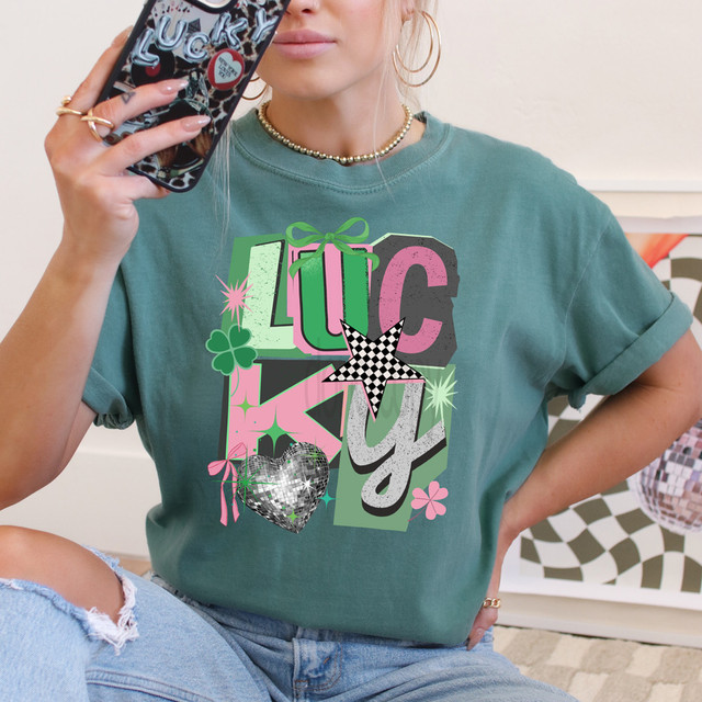 Retro Lucky DTF Heat Transfer, colorful graphic design with stars, hearts, four-leaf clover, and text on a teal T-shirt.