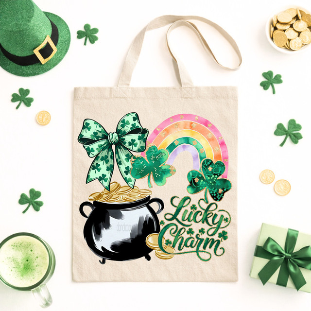 Lucky Charm Rainbow DTF Heat Transfer, colorful shamrocks, rainbow, pot of gold, and leprechaun hat on a tote bag with St. Patrick's Day theme.