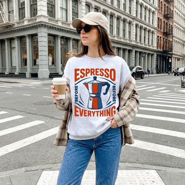 Espresso Before Everything DTF Heat Transfer, woman wearing a coffee-themed casual sweatshirt with coffee pot graphic on city street.