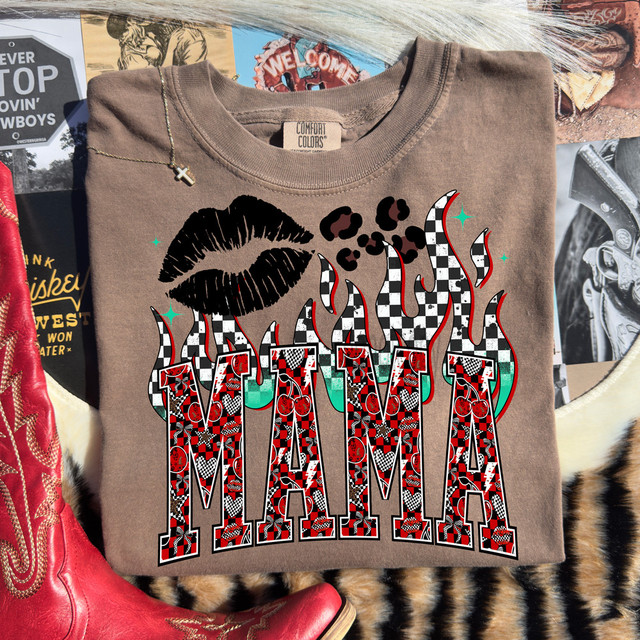 Retro Mama Flames DTF Heat Transfer, t-shirt with a design featuring a black lipstick kiss, flames, and bold letters filled with checkered and floral patterns.