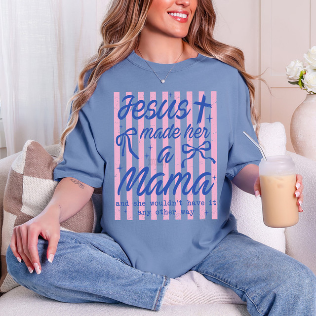 Jesus Made Her A Mama Stripes DTF Heat Transfer, pink and blue striped design with text on a woman's blue t-shirt.