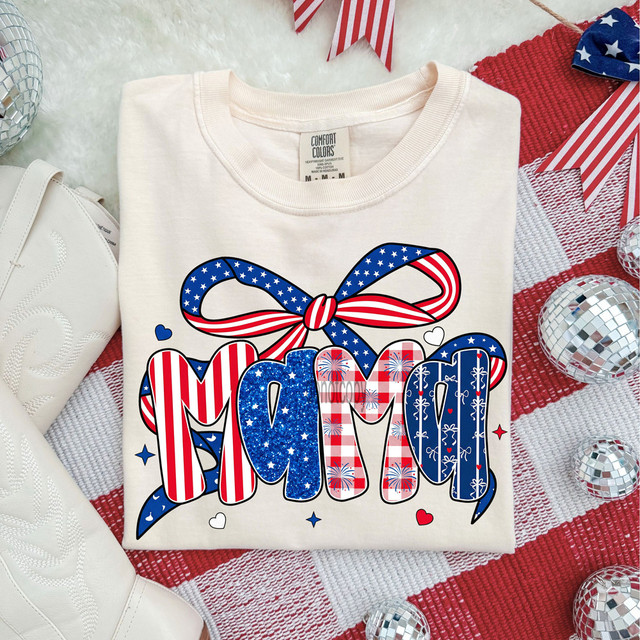 Patterned USA Mama DTF Heat Transfer, patriotic-themed design with a bow and the word 'Mom' in patriotic patterns and colors on a white T-shirt.