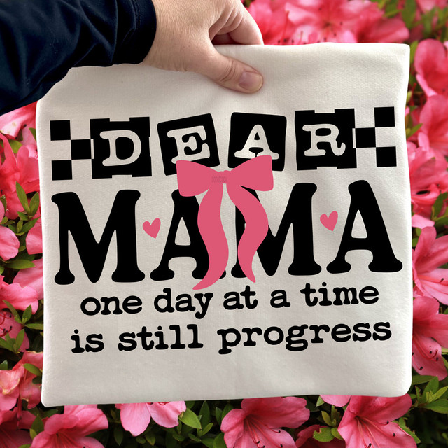 Dear Mama Bow BLACK DTF Heat Transfer, fabric tote bag with a pink bow design and the quote 'one day at a time is still progress' surrounded by pink flowers.