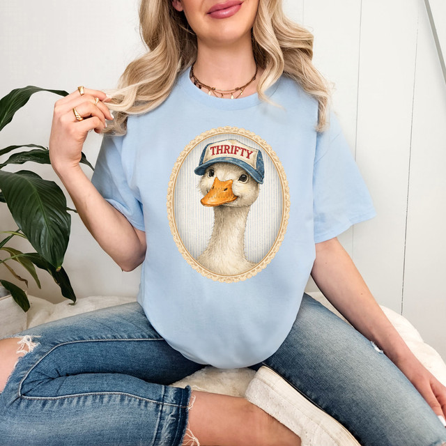Thrifty Goose DTF Heat Transfer, illustrated goose wearing a blue cap labeled 'THRIFTY' on a light blue T-shirt.