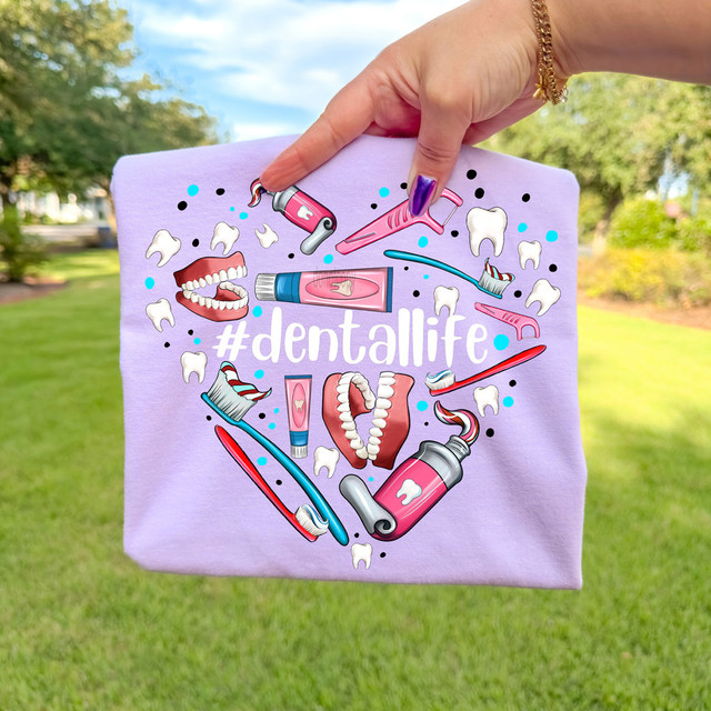 #dentallife WHITE DTF Heat Transfer, decorative print featuring dental tools, teeth, and mouth illustration on a purple fabric background.