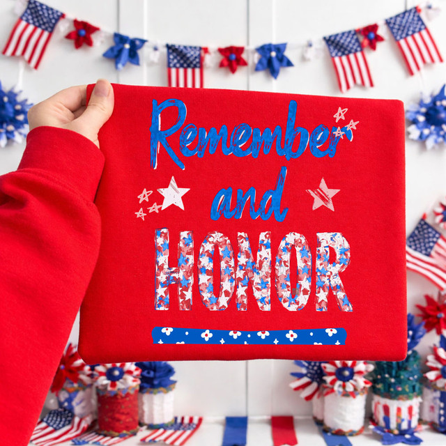 Remember And Honor Patriotic DTF Heat Transfer, featuring a red fabric with patriotic patriotic design and text, with blue, white, and red colors, against a background decorated with American flags and patriotic banners.