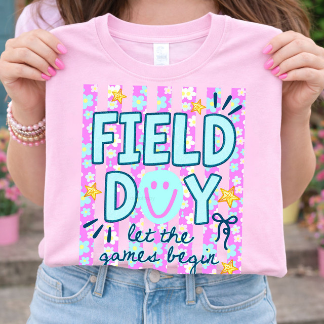 Field Day Let The Games Begin DTF Heat Transfer, pink T-shirt with colorful floral and striped pattern and playful text design.