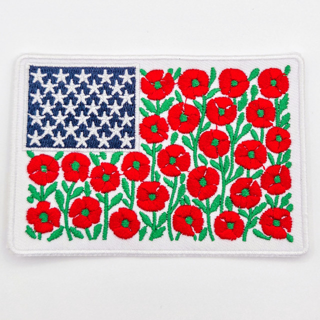 Floral American Flag Embroidered Patch – Red Poppy Patriotic Patch for Hat Bars & Boutiques, embroidered patch with American flag design and vibrant red poppies on a white background.