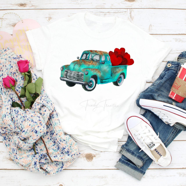 Vintage truck hearts Valentine's Day Sublimation Transfer, on a white t-shirt featuring a distressed teal vintage truck carrying red hearts.