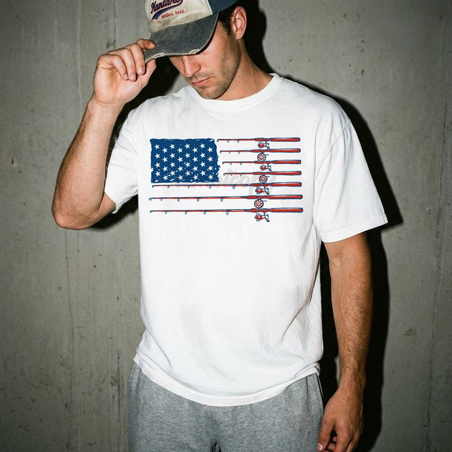 Fishing Flag DTF Heat Transfer, product image of a man wearing a white t-shirt with a patriotic fishing design featuring the American flag and fishing rods.