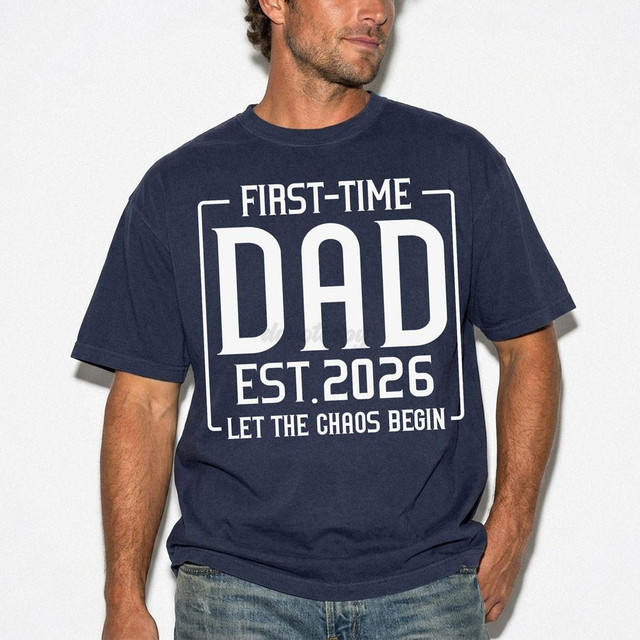 First Time Dad EST 2026 Let The Chaos Begin DTF Heat Transfer, image of a man wearing a navy blue T-shirt with a white printed design showing the message 'First Time Dad EST 2026 Let The Chaos Begin'.