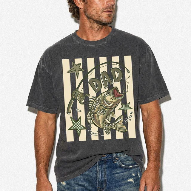 Fishing Dad DTF Heat Transfer, a graphic t-shirt featuring a jumping fish, fishing rod, and stars design.