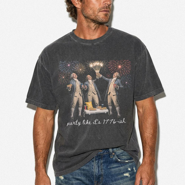Party Like It's 1776-ish DTF Heat Transfer, graphic t-shirt with Revolutionary War era men celebrating with fireworks and holding drinks.