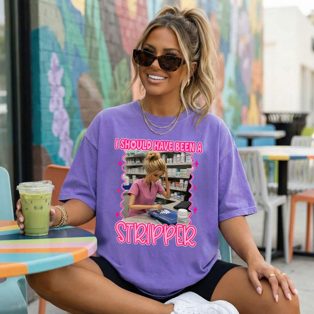 I Should Have Been A Stripper Pharmacy DTF Heat Transfer, purple T-shirt featuring a humorous graphic of a woman with the caption 'I SHOULD HAVE BEEN A STRIPPER'.