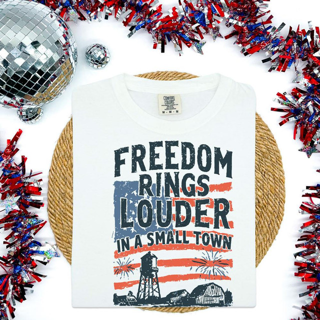 Freedom Rings Louder In A Small Town DTF heat transfer, design on a white t-shirt with patriotic graphic and text about small town life.