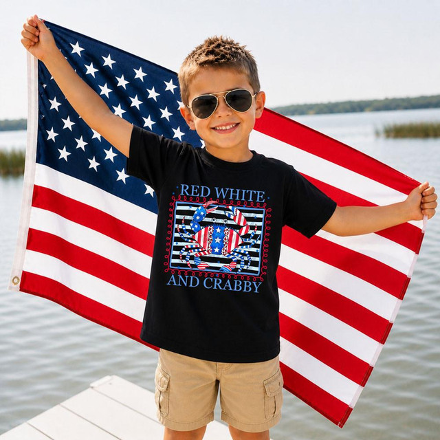 Red White And Crabby DTF Heat Transfer, a colorful crab design with patriotic stars and stripes on a boy holding an American flag outside by the water.