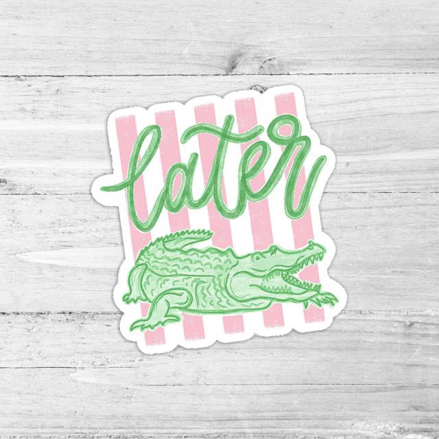 Later Gator Die Cut Vinyl Sticker, neon green alligator with open mouth and detailed scales, pink and white striped background, designed for decorative use on various surfaces.
