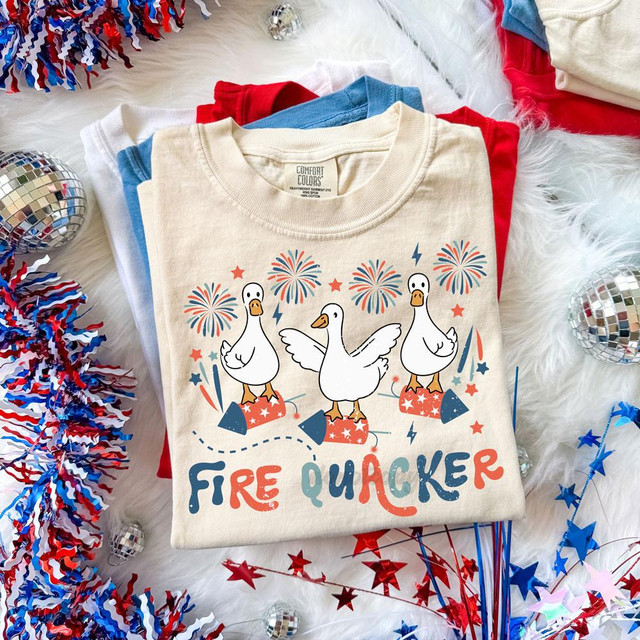 Fire Quacker DTF Heat Transfer, fun cartoon duck design with fireworks and celebratory elements on a white t-shirt.