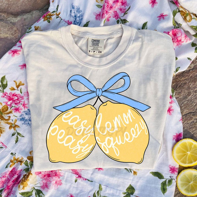 Easy Peasy Lemon Squeezy Bow DTF Heat Transfer, colorful lemon graphic with a blue bow on a white t-shirt, summery design.