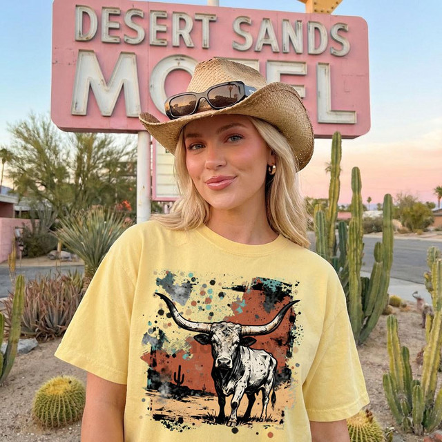 Rustic Longhorn DTF Heat Transfer, graphic of a longhorn steer with desert scenery in the background on a yellow T-shirt.