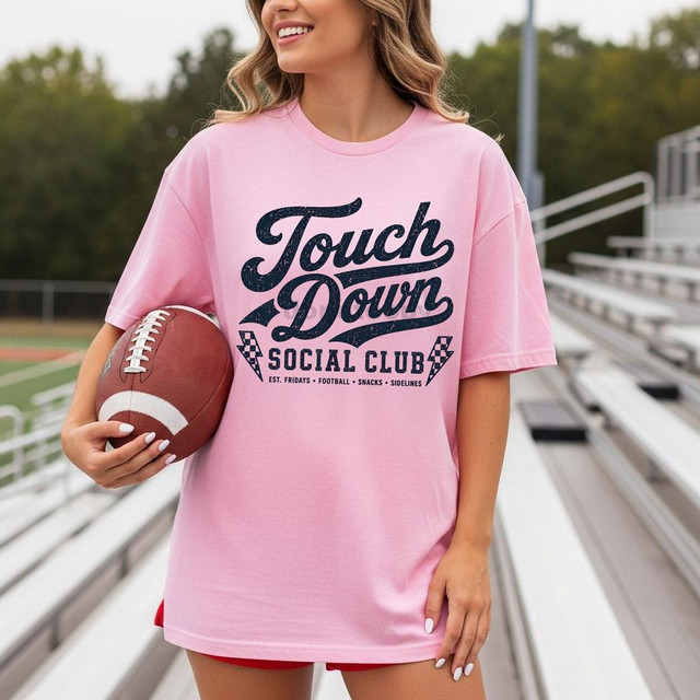 Touchdown Social Club NAVY DTF Heat Transfer, displayed on a pink t-shirt worn by a woman holding a football.