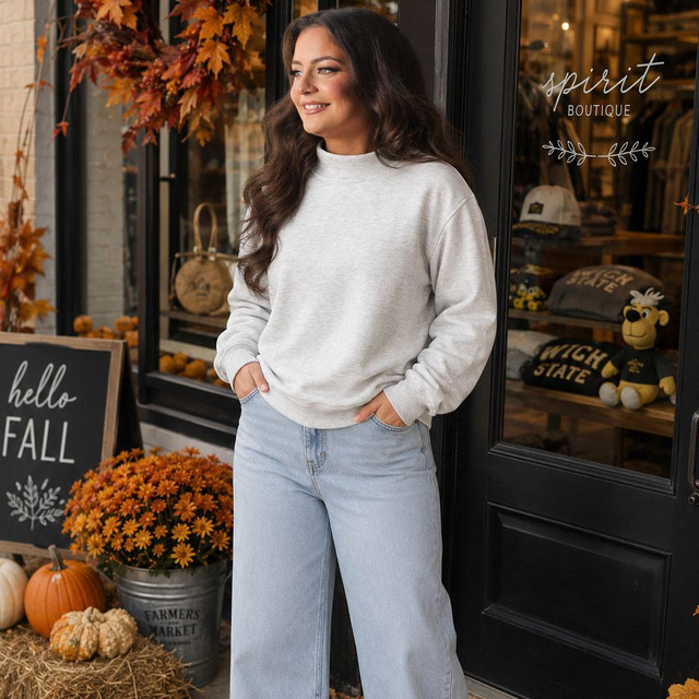 Blank Mockneck Sweatshirt — Preorder in multiple colors, worn by a woman standing outdoors next to a store with fall decorations.