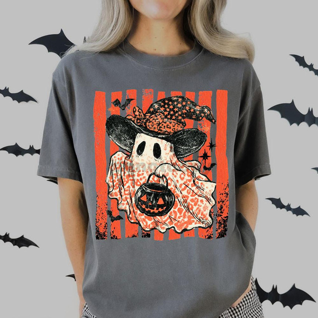 Leopard Ghost DTF Heat Transfer, Halloween-themed design featuring a ghost with a leopard print hat and pumpkin-shaped purse on a gray T-shirt.