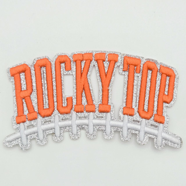 Rocky Top Football Puff Embroidered & Glitter Hat Patch, embroidered patch featuring the word 'ROCKY TOP' in orange puff embroidery with silver glitter outline and a white embroidered football lace design.