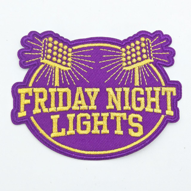 Friday Night Lights Embroidered Hat Patch, purple and gold patch with two lit firework illustrations and bold text.