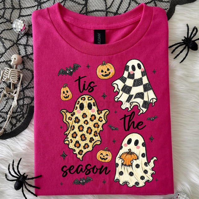 Tis The Season Patterned Ghosts DTF Heat Transfer, a pink T-shirt featuring Halloween-themed ghost and pumpkin illustrations with the text 'tis the season'.