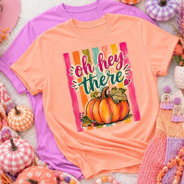 Oh Hey There Pumpkin DTF Transfer, colorful pumpkin-themed design on peach-colored T-shirt with vibrant fall colors and graphics.