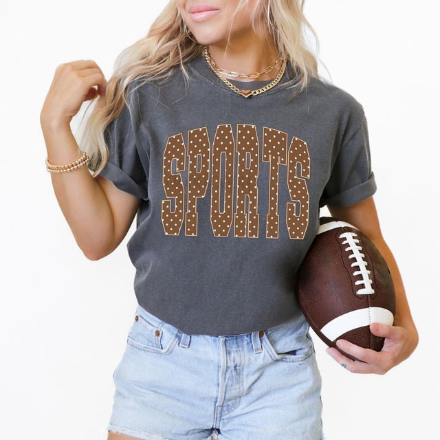 Minimalist Polka Dot Sports DTF Heat Transfer, girl holding football and wearing a graphic t-shirt with polka dot design.