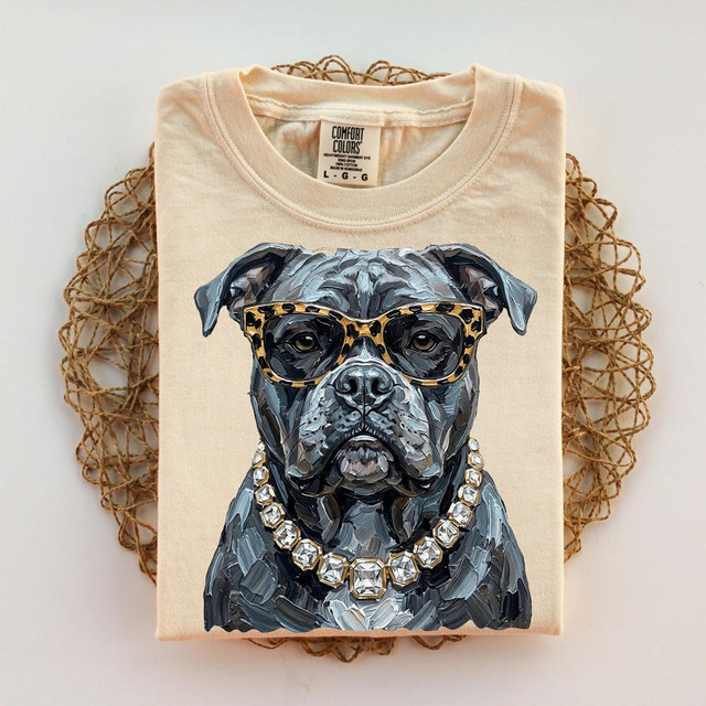 Glam Bulldog DTF Transfer, close-up of a T-shirt with a graphic of a bulldog wearing leopard-print glasses and a diamond necklace.