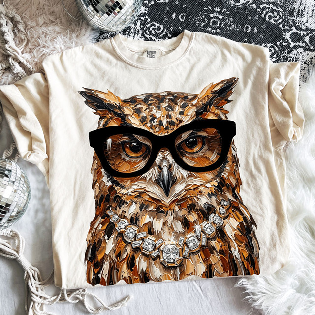 Glam owl DTF transfer with oversized black glasses and jeweled necklace displayed on cream Comfort Colors T-shirt